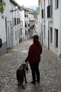 Janni and Shiloh on a cobblestone street with building on both sides.